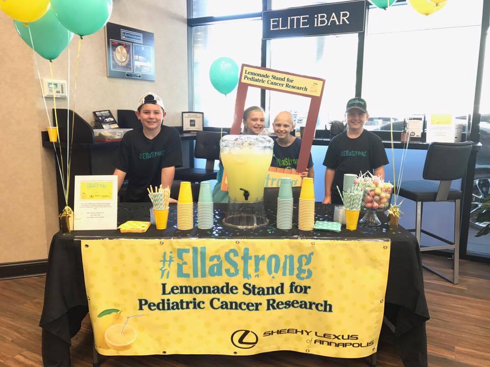 Kids behind the #EllaStrong Lemonade Stand for Pediatric Cancer Research banner